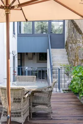 a table and chairs with an umbrella on a deck at Porto Premium Villa in Porto