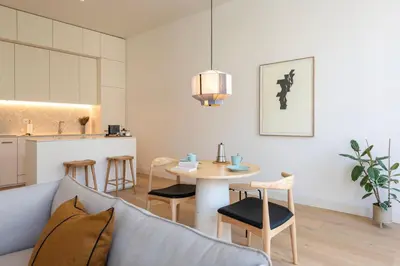 a white kitchen with white cabinets and a stove at Mouzinho 32 in Porto