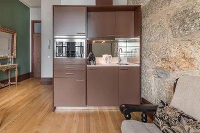 a kitchen with stainless steel appliances in a room at GuestReady - Belle Epoque Apartments in Porto