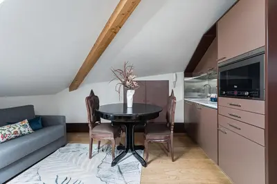 a kitchen and dining room with a table and a couch at GuestReady - Belle Epoque Apartments in Porto