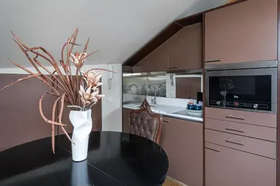 a kitchen with a table with a vase of flowers on it at GuestReady - Belle Epoque Apartments in Porto
