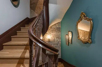 a stairway with a mirror on the wall at GuestReady - Belle Epoque Apartments in Porto