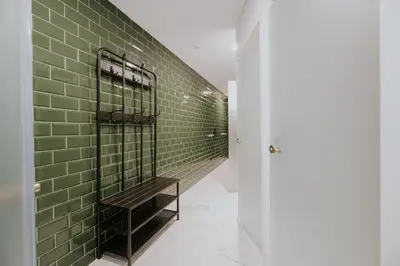 a green tiled hallway with a bench in it at Porto Hostel Cúpula in Porto