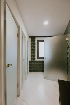 a hallway with a door and a brick wall at Porto Hostel Cúpula in Porto
