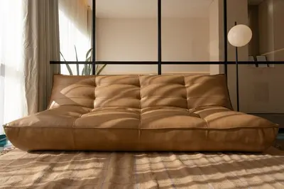 a brown couch sitting in a living room at Stylish Downtown Loft in Porto