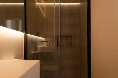 a bathroom with a shower with a glass door at Stylish Downtown Loft in Porto