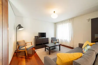 a living room with a couch and a table at Modern Cedofeita by Hosty in Porto