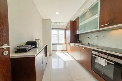 a kitchen with a sink and a stove top oven at Modern Cedofeita by Hosty in Porto