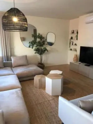 a living room with a couch and a tv at Amazing Penthouse with a Terrace in Porto