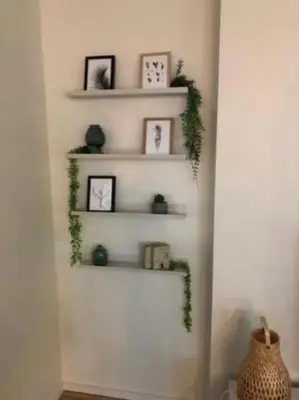 a room with white shelves with clocks and plants at Amazing Penthouse with a Terrace in Porto