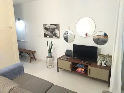 a living room with a couch and a table at Cais das Pedras Pátio Apartment - with washer and dryer machine in Porto