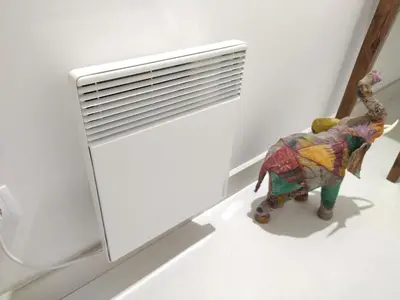 a toy elephant standing next to a radiator at Cais das Pedras Pátio Apartment - with washer and dryer machine in Porto