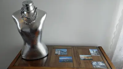 a silver vase sitting on a wooden table with pictures at Alegria Apartment Porto Downtown in Porto