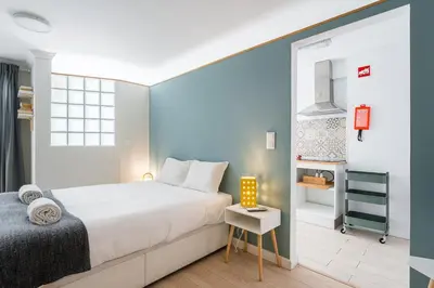 a bedroom with a white bed and a blue wall at GuestReady - Porto by Pilar Ridge in Vila Nova de Gaia