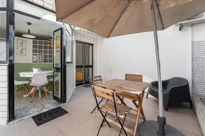 a patio with a table and chairs and an umbrella at GuestReady - Porto by Pilar Ridge in Vila Nova de Gaia