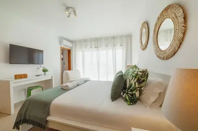 a bedroom with a bed with a mirror and a tv at Rooftop Stylish by Hosty in Porto