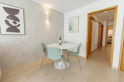 a dining room with a white table and chairs at Stylish Apartment With Terrace by Hosty in Porto