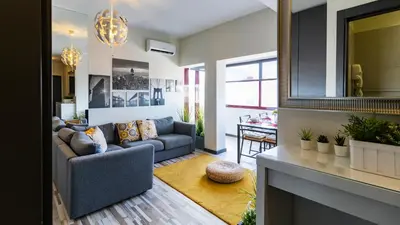 a living room with a couch and a fireplace at Abadia by LovelyStay in Porto