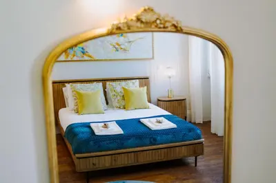 a bedroom with a bed with a large mirror at Romantic Luxury House w Captivating Outdoor Patio in Porto