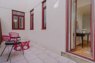 a room with red chairs and a table and a piano at Romantic Luxury House w Captivating Outdoor Patio in Porto