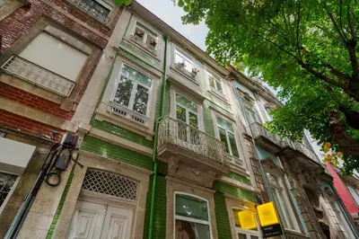 an old house with green and white trim at Exclusive Charm House in Porto
