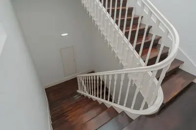 an empty stairway with a white railing and wooden floors at Exclusive Charm House in Porto