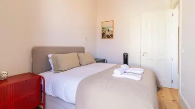 a bedroom with a bed with a towel on it at Duque Flat - AC & Balcony by LovelyStay in Porto