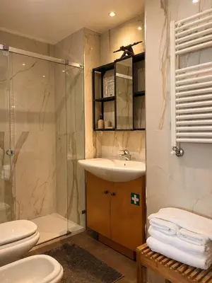 a bathroom with two toilets and a shower and a sink at Live Oporto K`Alma in Porto