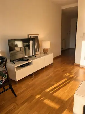 a living room with a white couch and a television at Live Oporto K`Alma in Porto