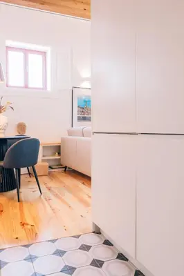 a kitchen and dining room with a table and a refrigerator at ORM - Cedofeita I Apartment in Porto