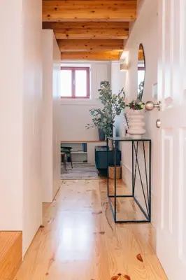 a hallway with a glass table on a wooden floor at ORM - Cedofeita I Apartment in Porto