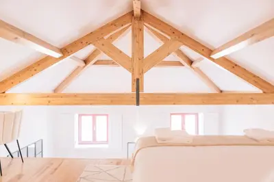 a bedroom with a white bed in a room with wooden ceilings at ORM - Cedofeita I Apartment in Porto