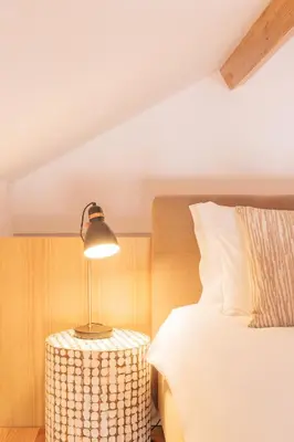 a bedroom with a bed and a lamp on a table at ORM - Cedofeita I Apartment in Porto