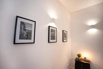 a room with three framed pictures on the wall at Host Wise - Peaceful Amazing Apartment - Ace Location in Porto