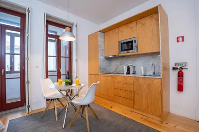 a kitchen with a table and chairs in a room at Host Wise - Peaceful Amazing Apartment - Ace Location in Porto
