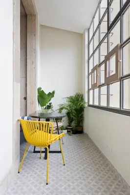 a living room with a green couch and a table at Ateneu Boutique Townhouse Bolhão in Porto