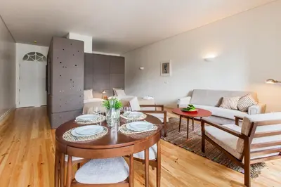 a living room with a table and a couch at bnapartments Loftpuzzle in Porto