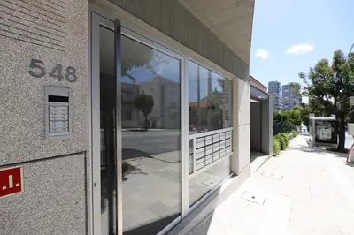 a building with large glass windows on the side of it at FLH Boavista Wooden Duplexes in Porto