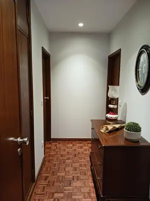 a hallway with a wooden dresser and a mirror at Portus Cale by LovelyStay in Vila Nova de Gaia