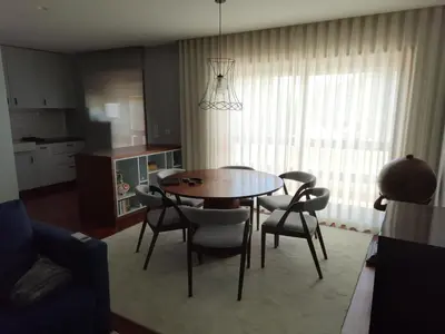 a living room with a dining room table and chairs at Portus Cale by LovelyStay in Vila Nova de Gaia