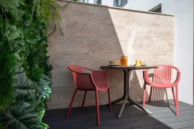 two red chairs and a table on a patio at Patio de Flores in Porto