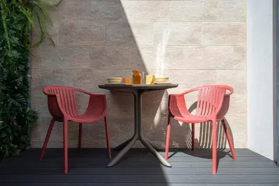 a table with two chairs and a table with drinks on it at Patio de Flores in Porto