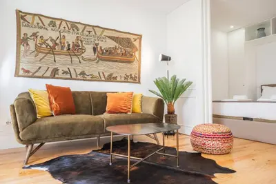 a living room with a couch and a table at Patio de Flores in Porto