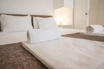 a bedroom with two white towels on a bed at Patio de Flores in Porto