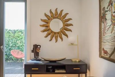 a mirror on a wall above a dresser in a room at Patio de Flores in Porto