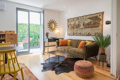 a living room with a couch and a table at Patio de Flores in Porto