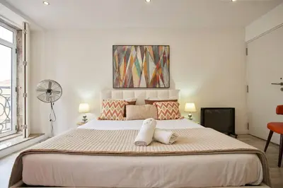 a bedroom with a large bed with two pillows on it at So Simply Ribeira in Porto