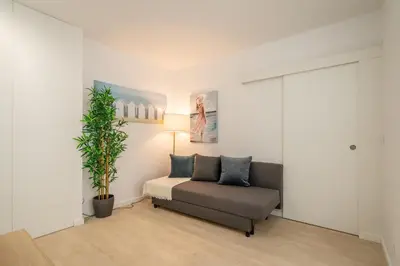 a living room with a couch and a plant at Host Wise - Peaceful Sunny Flat - Ace Location in Porto