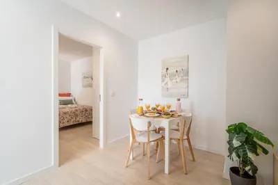 a white dining room with a white table and chairs at Host Wise - Peaceful Sunny Flat - Ace Location in Porto