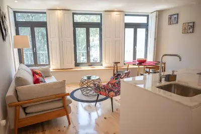 a kitchen and living room with a couch and a table at Truly Porto in Porto